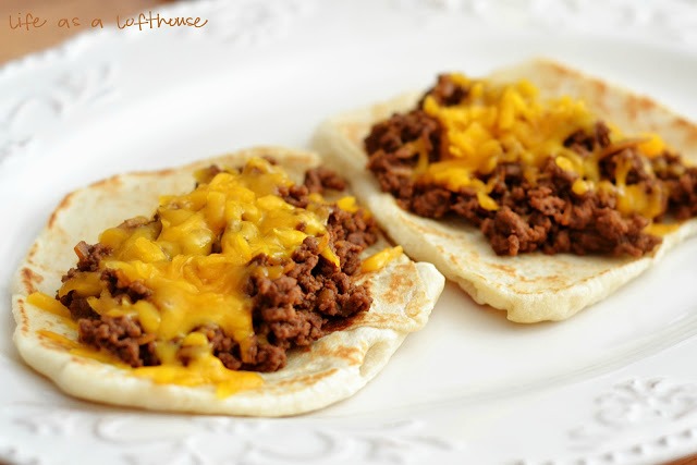 Cheeseburger Flatbread Melts are made up of a 'burger' meat mixture topped off with shredded cheddar cheese that is wrapped up in a flatbread. Life-in-the-Lofthouse.com