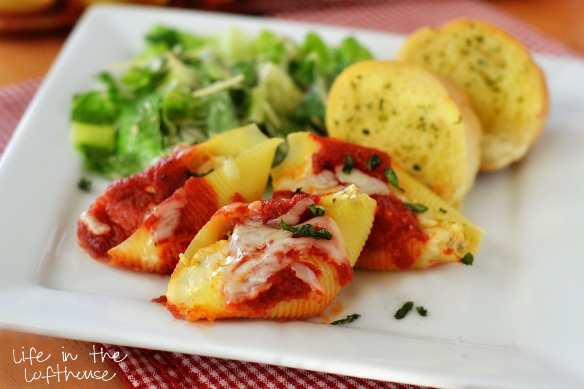Chicken stuffed shells with pesto and cheese.