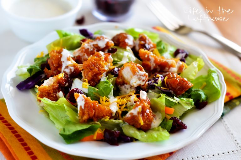 This delicious salad is full of crunchy romaine lettuce, dried cranberries, shredded carrots, cheese, and of course those amazing sticky chicken fingers. Life-in-the-Lofthouse.com
