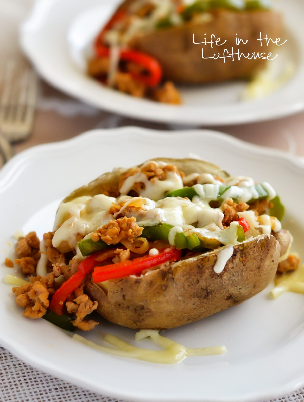 Baked Potatoes topped with a chicken cheesesteak filling. Life-in-the-Lofthouse.com