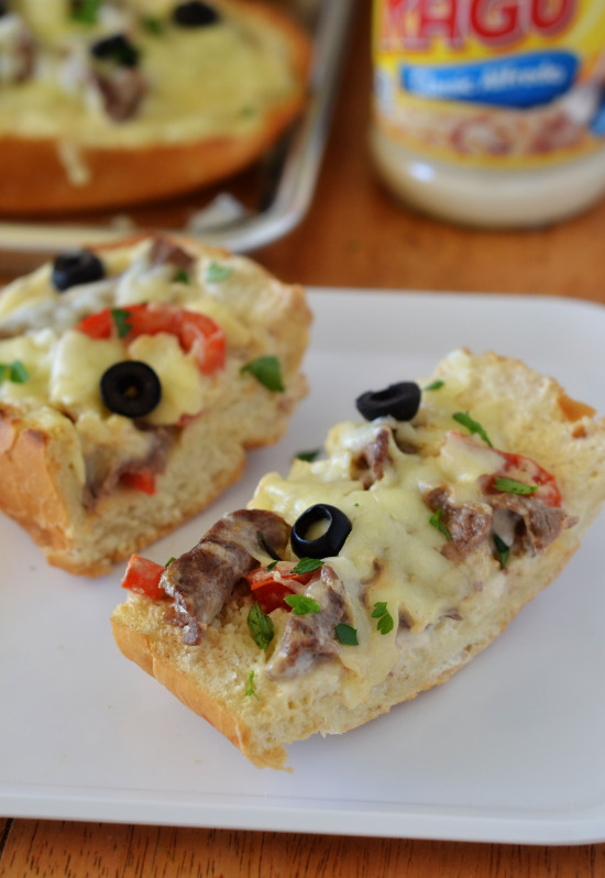 Think steak, cheese and bell peppers tossed in creamy Rag&ugrave;&reg; Cheese Creations Classic Alfredo Sauce baked on French bread make up this Italian cheese steak french bread pizza. Life-in-the-Lofthouse.com