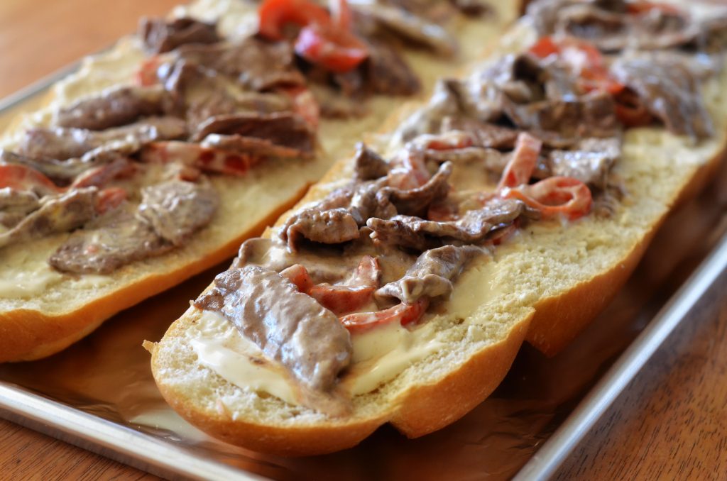 Think steak, cheese and bell peppers tossed in creamy Rag&ugrave;&reg; Cheese Creations Classic Alfredo Sauce baked on French bread make up this Italian cheese steak french bread pizza. Life-in-the-Lofthouse.com