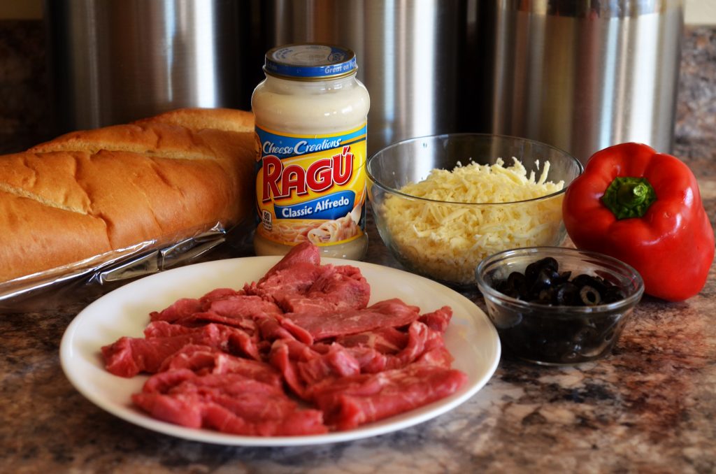 Think steak, cheese and bell peppers tossed in creamy Rag&ugrave;&reg; Cheese Creations Classic Alfredo Sauce baked on French bread make up this Italian cheese steak french bread pizza. Life-in-the-Lofthouse.com