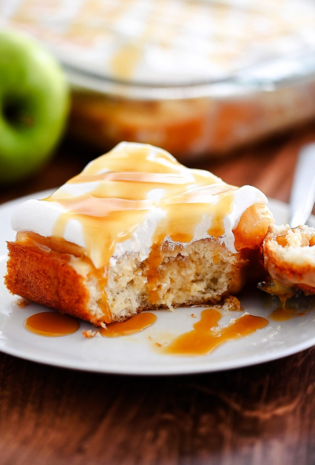 Caramel apple poke cake is a light and moist cake that tastes like caramel apples. Life-in-the-Lofthouse.com