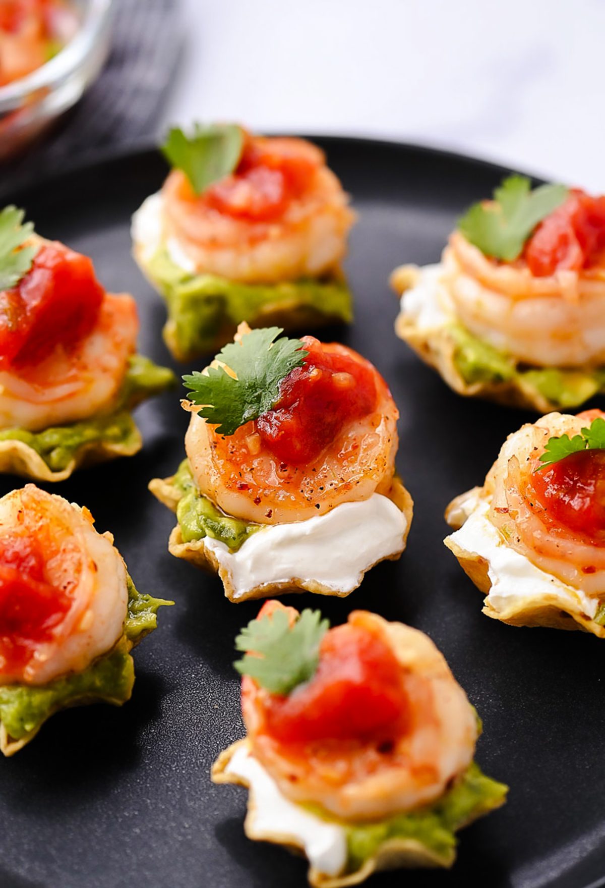 Juicy, marinated shrimp in a tangy honey-lime sauce are nestled in crunchy tortilla scoops and topped with smooth avocado, cool sour cream, and vibrant fresh salsa.