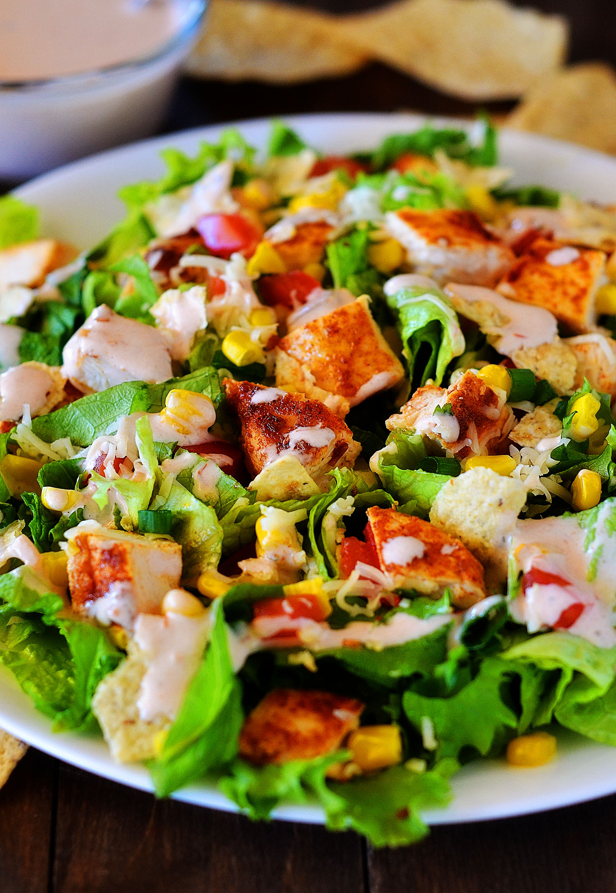 This Chicken Taco Salad is loaded with grilled chicken, corn, tomatoes and&nbsp;green onion over a bed of romaine lettuce. Life-in-the-Lofthouse.com