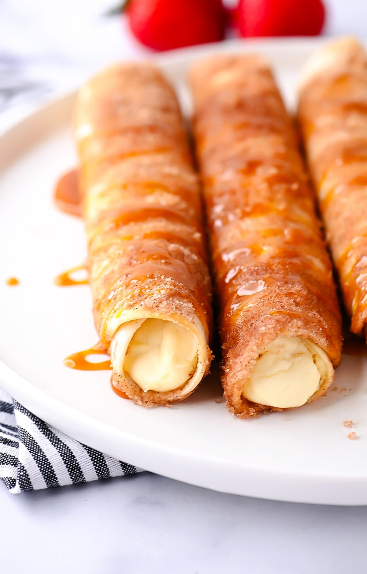 Cheesecake Taquitos have a silky-smooth cheesecake filling wrapped inside a crispy flour tortilla that's been rolled in cinnamon and sugar. Life-in-the-Lofthouse.com