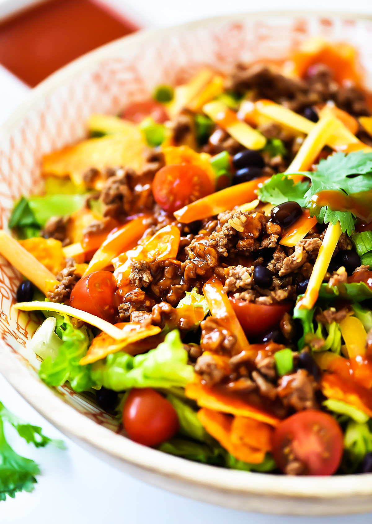 This Doritos Taco Salad is loaded with seasoned ground beef, black beans and of course, Nacho Cheese Doritos. Life-in-the-Lofthouse.com