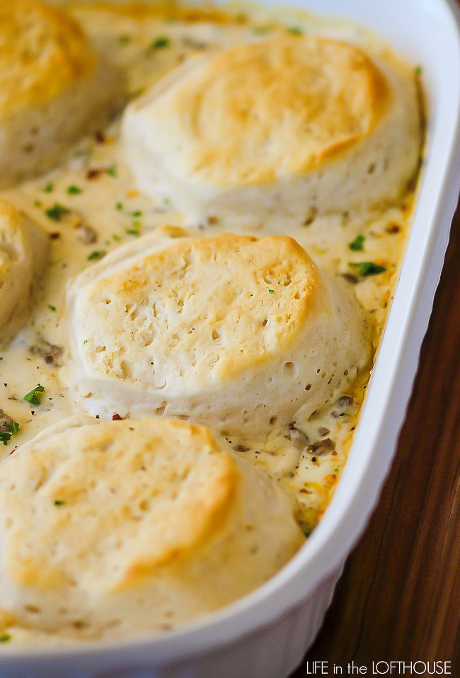 Biscuits and gravy casserole is a delicious breakfast with flaky biscuits that puff up and get golden over the sausage and creamy gravy. Life-in-the-Lofthouse.com