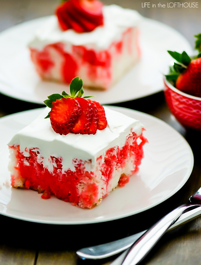 Incredibly light and delicious Strawberry Jello Poke Cake! This white cake is filled with strawberry jello and topped with fresh whipped cream and strawberries.