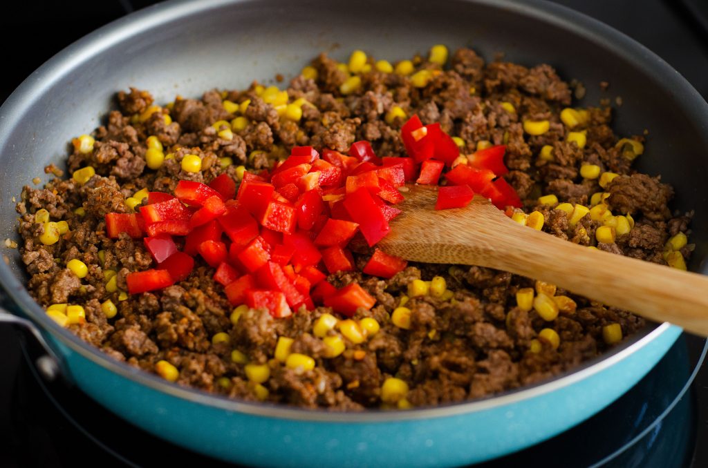 A delicious skillet with noodles, ground beef, olives and red bell peppers with taco seasonings. Life-in-the-Lofthouse.com