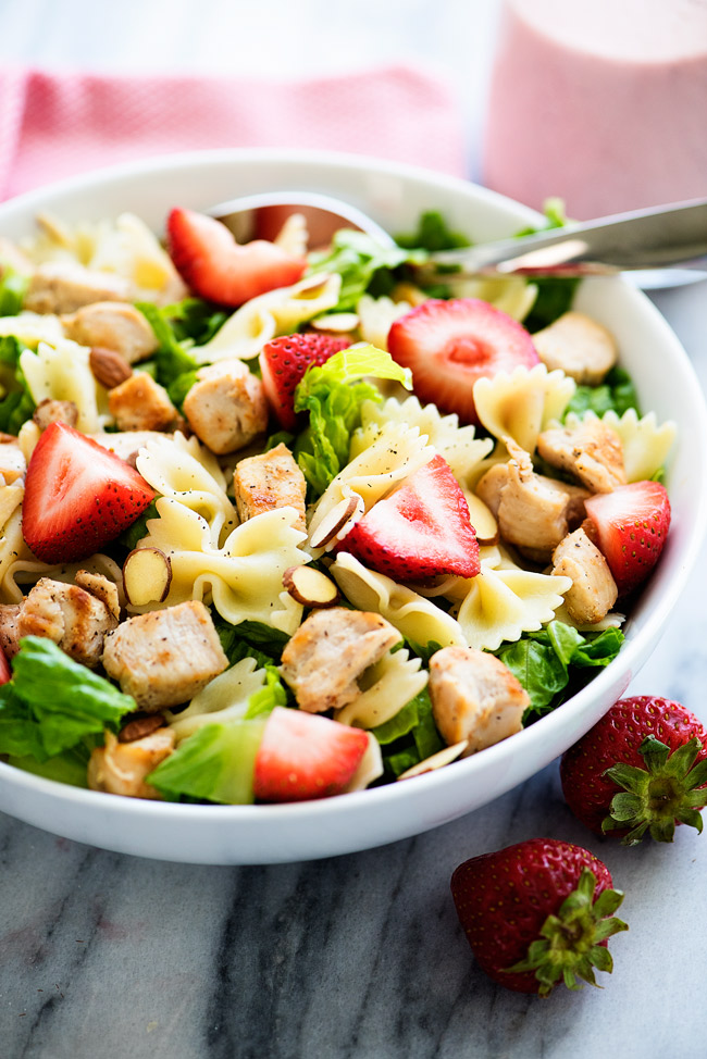 This salad is loaded with grilled chicken, strawberries, bow tie noodles and romaine lettuce. We love to pour poppy seed dressing over the top!