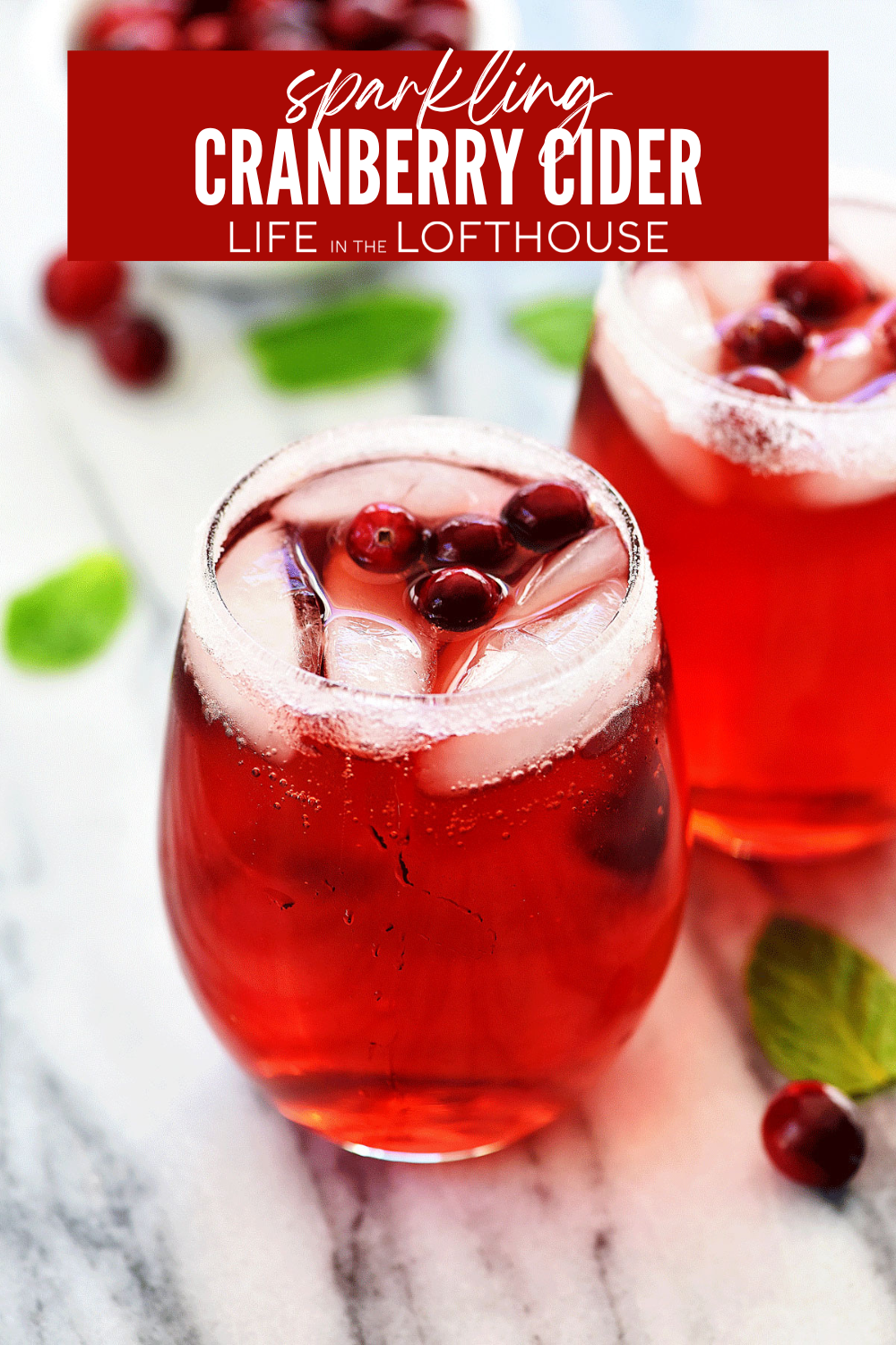 Sparkling Cranberry Cider with fresh cranberries in a glass