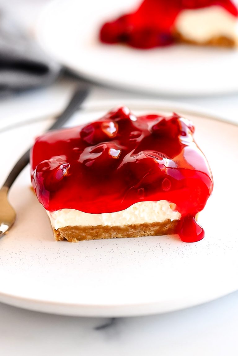 Cherry Delight is an easy dessert recipe with a graham cracker crust, a cheesecake center and topped off with delicious cherry pie filling!