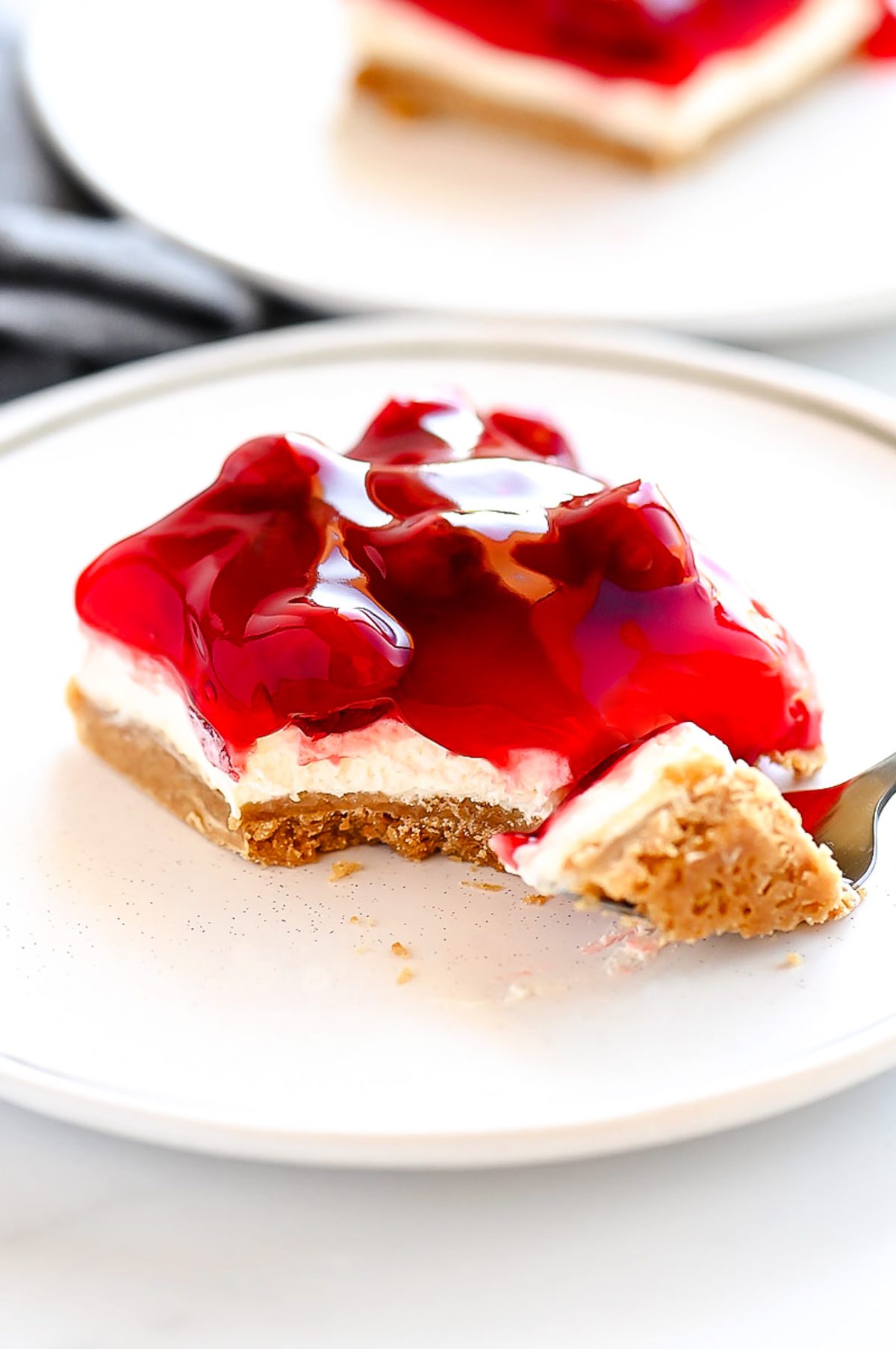 Cherry Delight is an easy dessert recipe with a graham cracker crust, a cheesecake center and topped off with delicious cherry pie filling!