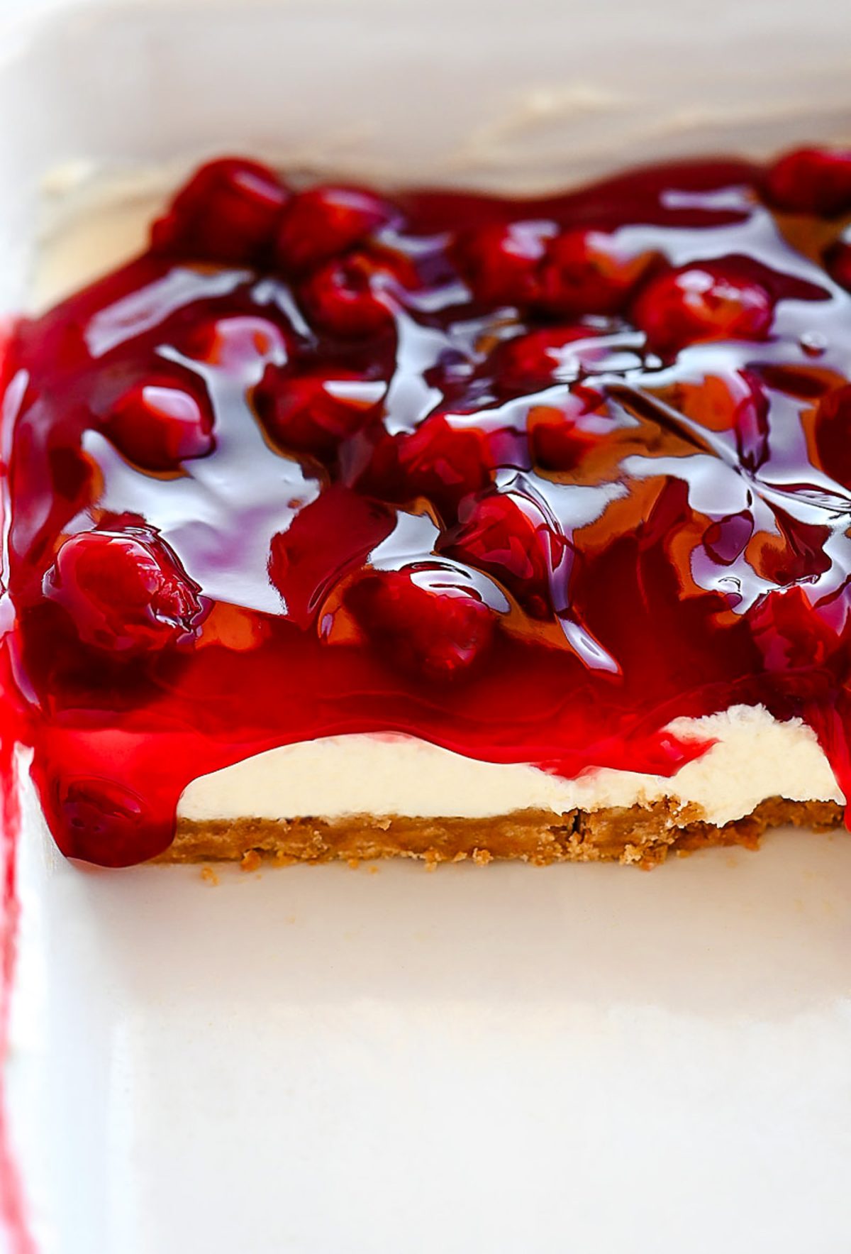 Cherry Delight is an easy dessert recipe with a graham cracker crust, a cheesecake center and topped off with delicious cherry pie filling!