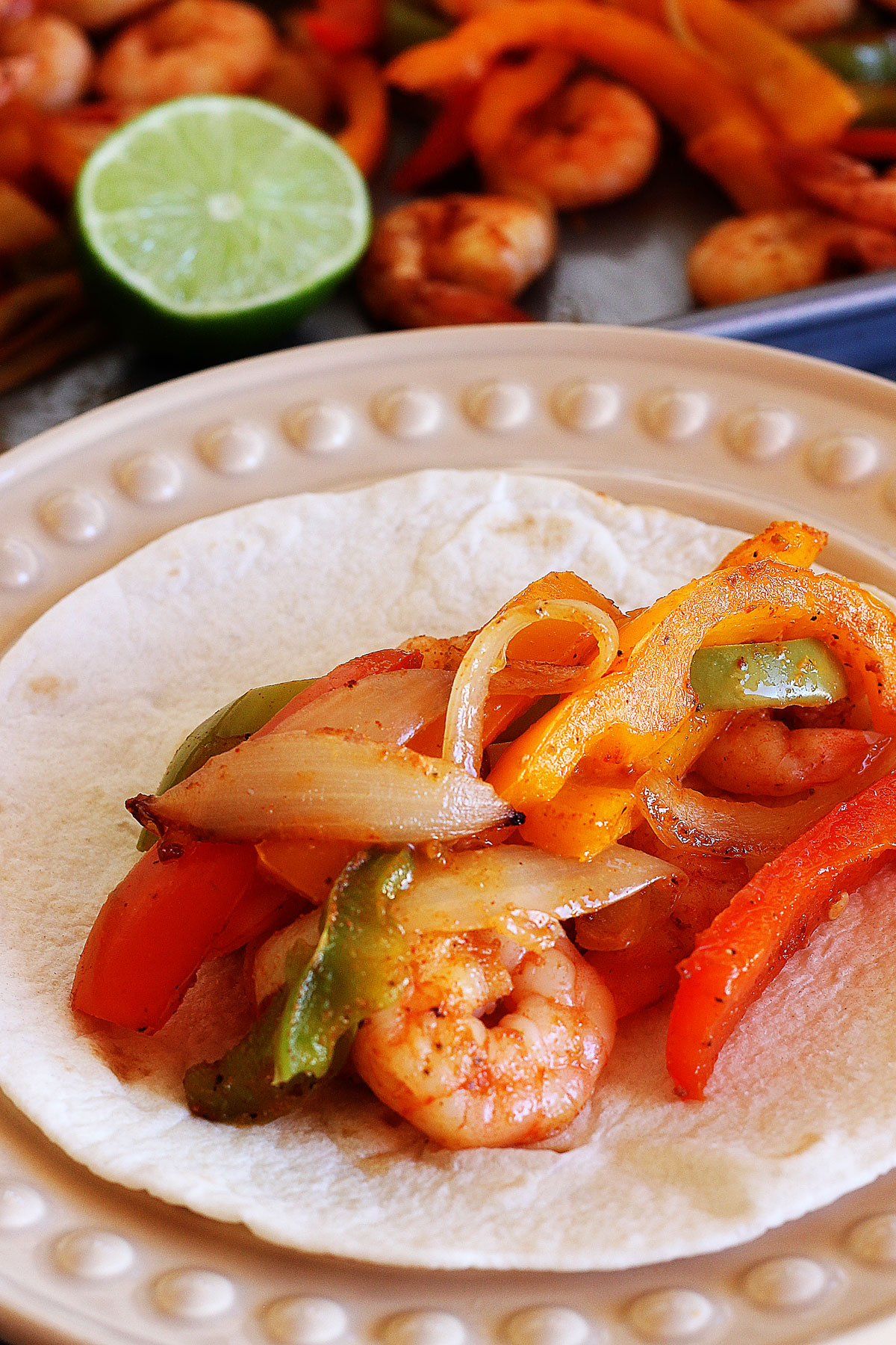 These sheet pan Shrimp Fajitas are slightly spicy and full of peppers and onions with hints of lime. Life-in-the-Lofthouse.com