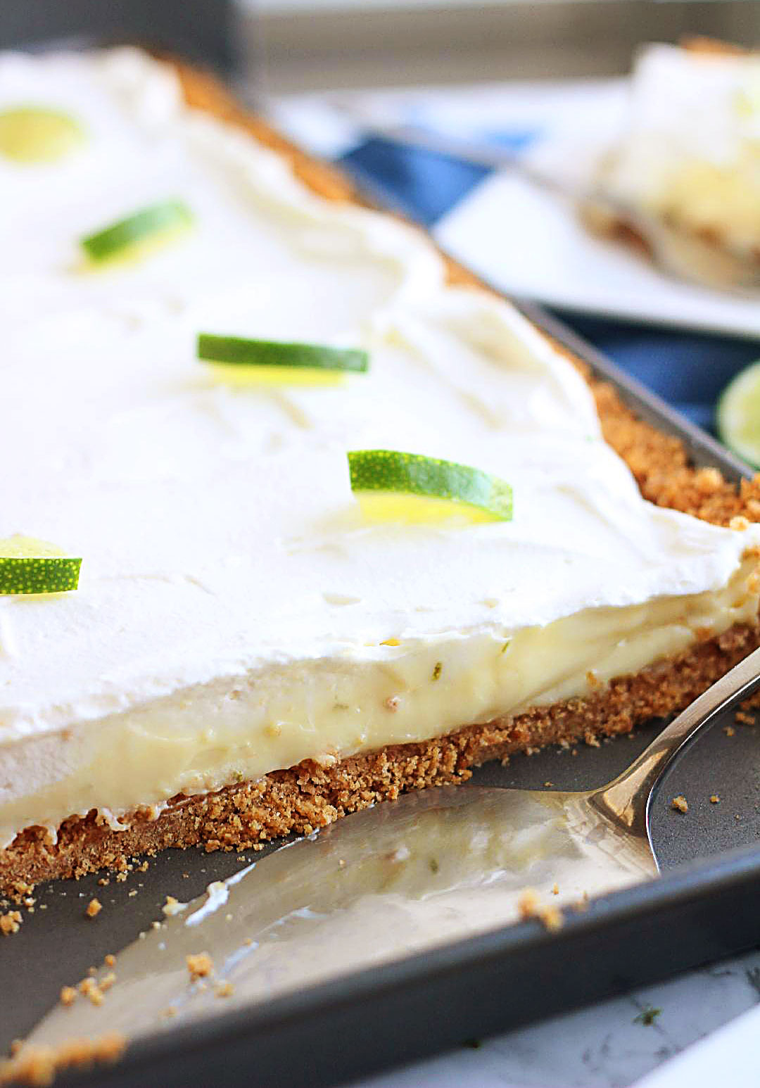 Key Lime Slab Pie is a creamy, refreshing pie full of lime flavor with a graham cracker crust. Life-in-the-Lofthouse.com