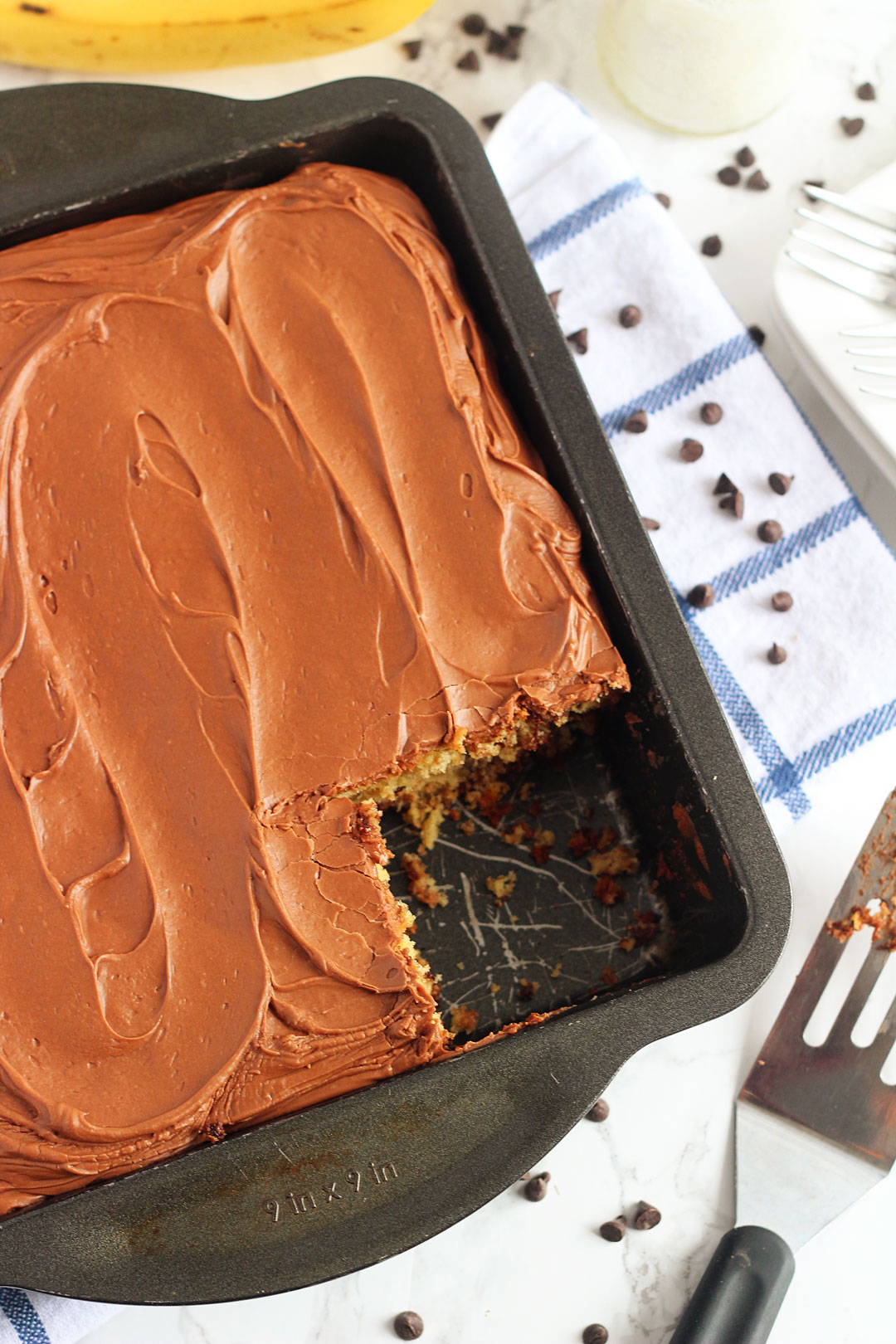 Chocolate Chip Banana Cake is a delicious, soft banana cake filled with chocolate chips and topped with a creamy chocolate frosting. Life-in-the-Lofthouse.com