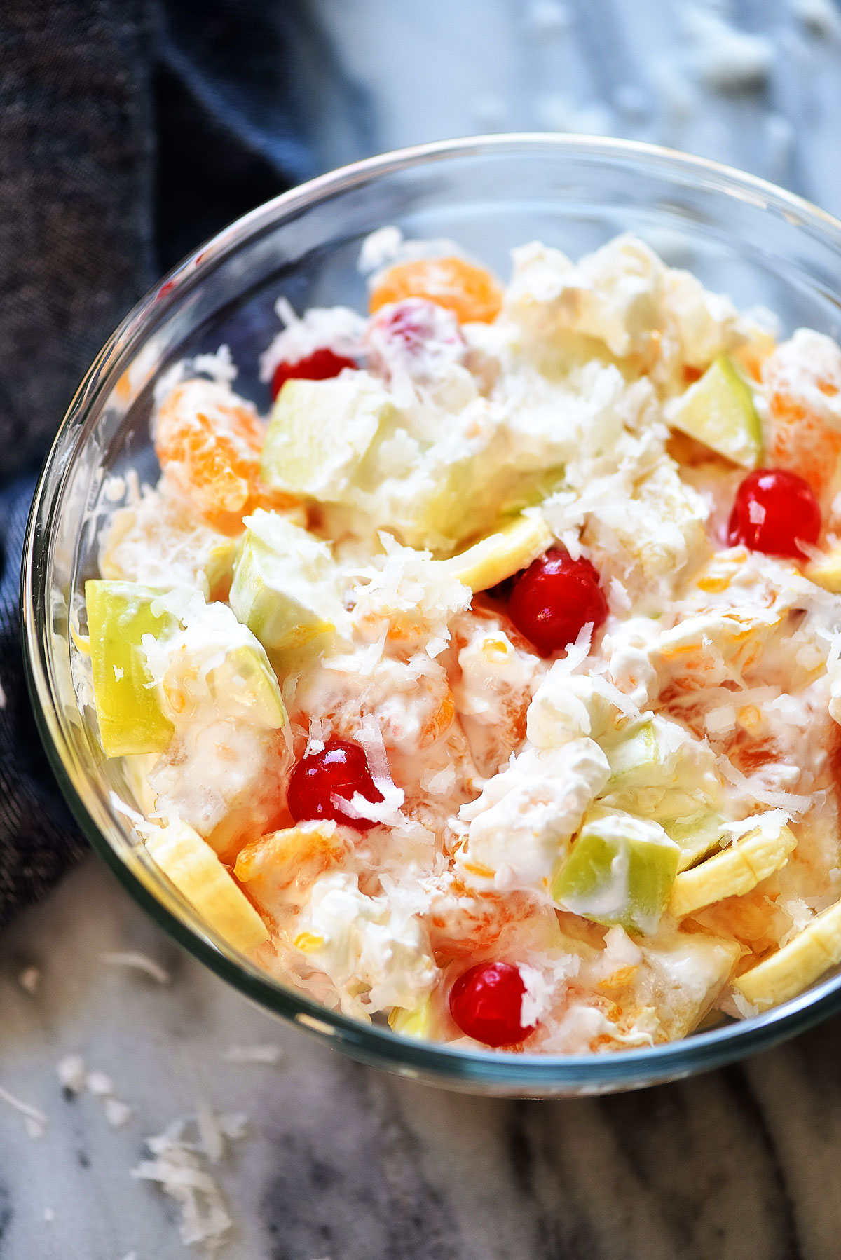 This Creamy Fruit Salad is filled with refreshing fruit, coconut shavings, marshmallows and whipped cream. Life-in-the-Lofthouse.com