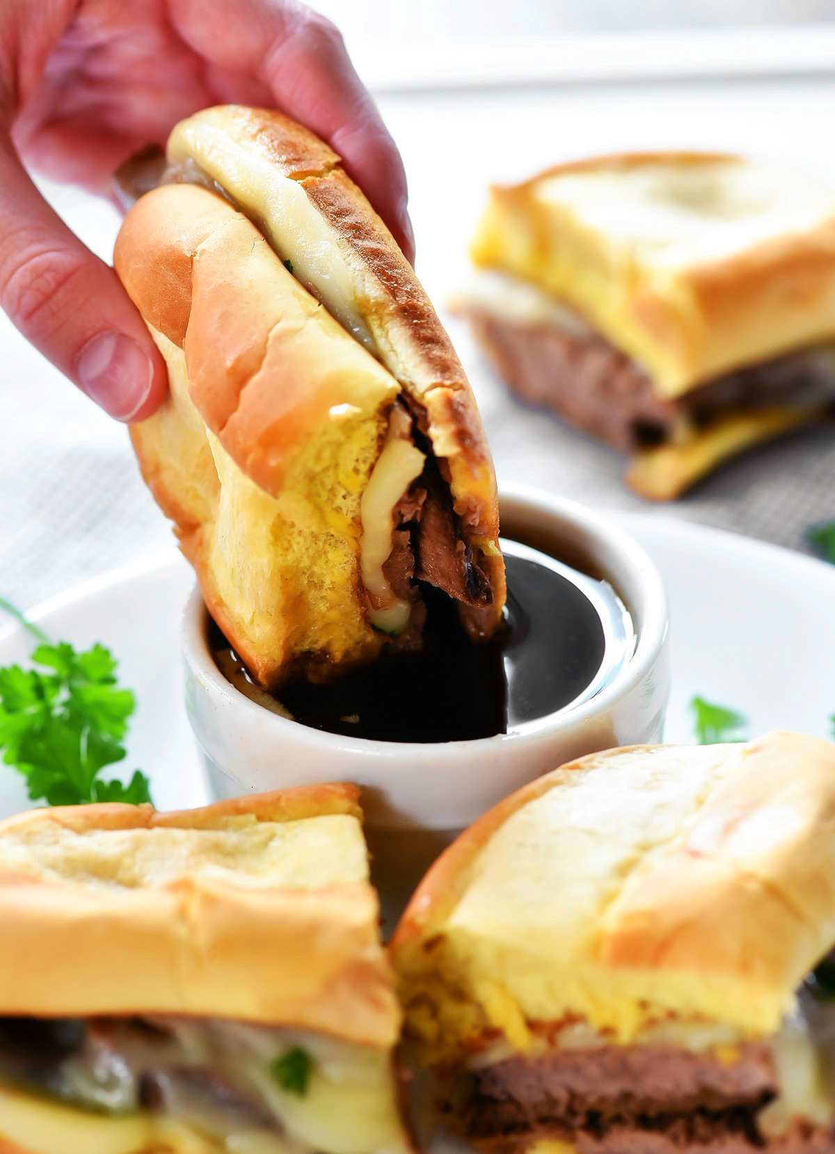 Slow Cooker French Dip Sandwiches are filled with tender slow cooked beef, topped with melty cheese and packed inside a toasty bun. Life-in-the-Lofthouse.com