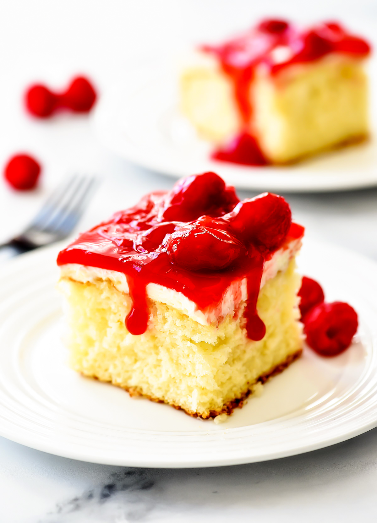 Raspberry Cream Cake is a moist and delicious white cake with a whipped cream cheese layer and raspberry glaze topping. These wonderful flavors together are amazing!