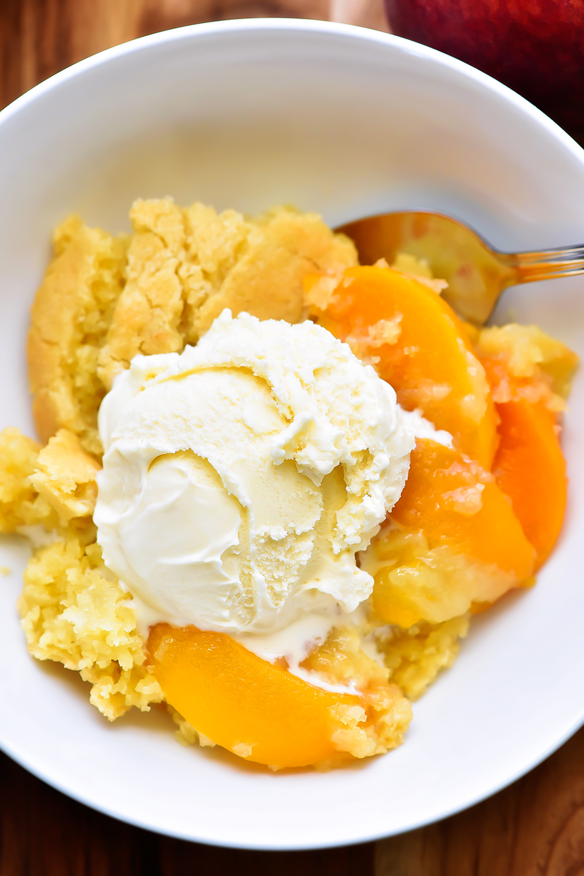 The Best Peach Cobbler is a delicious cake-like dessert made with sliced peaches and served warm with vanilla ice-cream. 