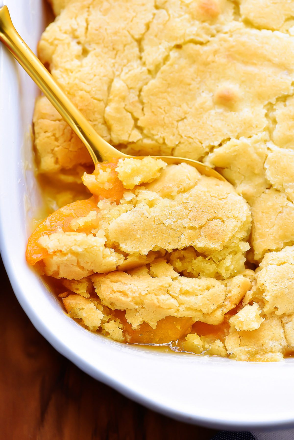 The Best Peach Cobbler is a delicious cake-like dessert made with sliced peaches and served warm with vanilla ice-cream. Life-in-the-Lofthouse.com