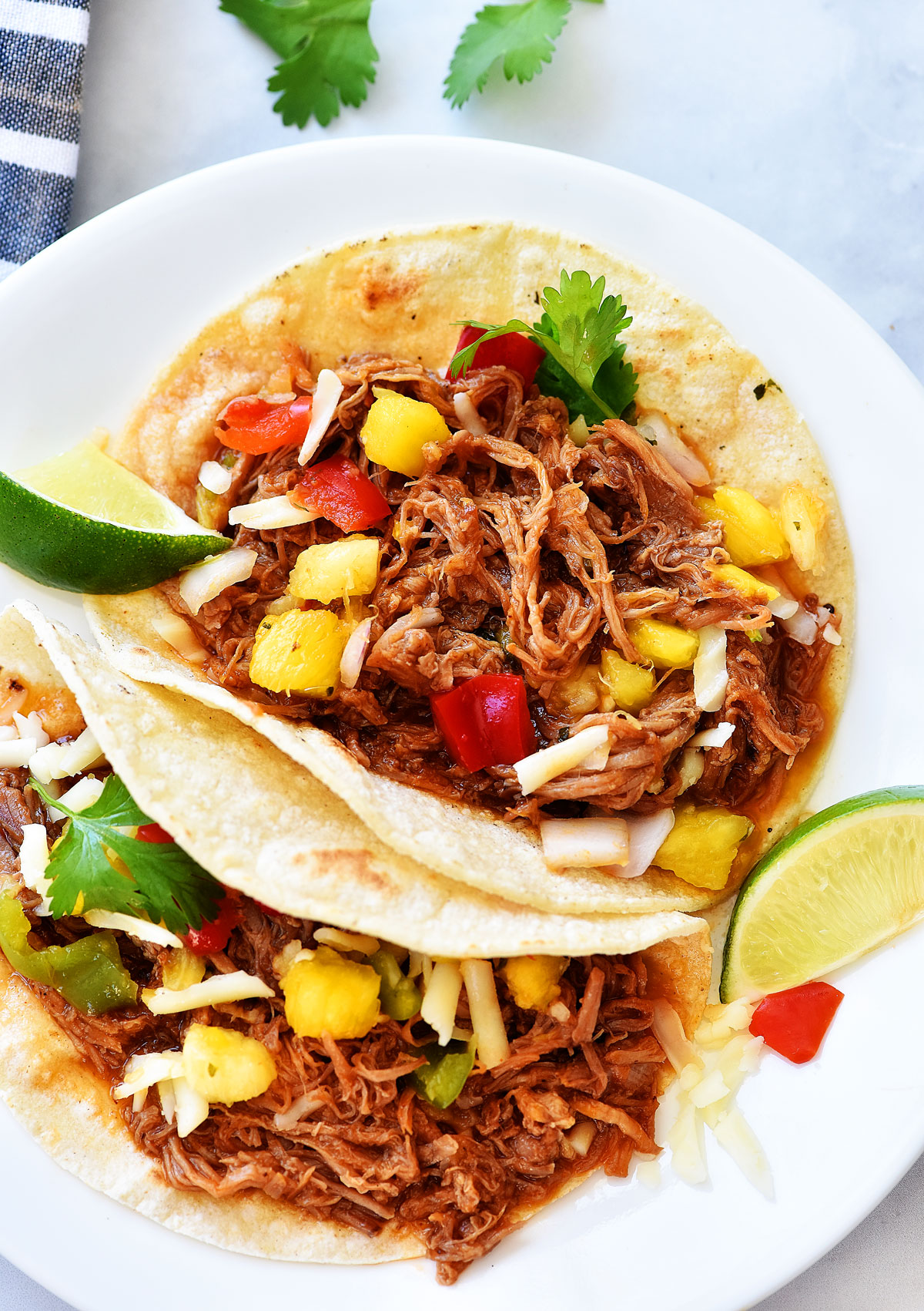 Sweet Pork tacos are tacos filled with tender sweet pork, Monterey jack cheese and pineapple salsa. Life-in-the-Lofthouse.com