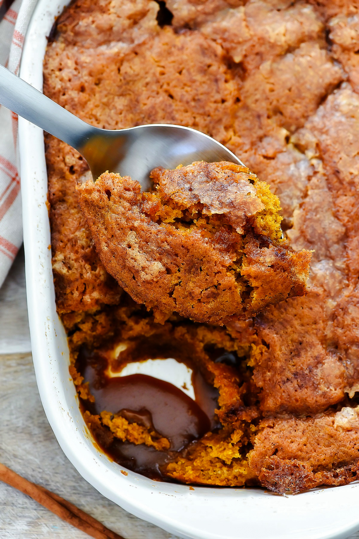 Indulge in a fluffy pumpkin cobbler with a gooey caramel sauce&mdash;perfect for fall gatherings! Easy to make, warm, and holiday-ready.