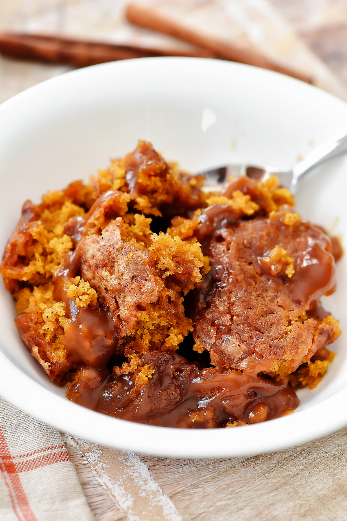 Indulge in a fluffy pumpkin cobbler with a gooey caramel sauce&mdash;perfect for fall gatherings! Easy to make, warm, and holiday-ready.