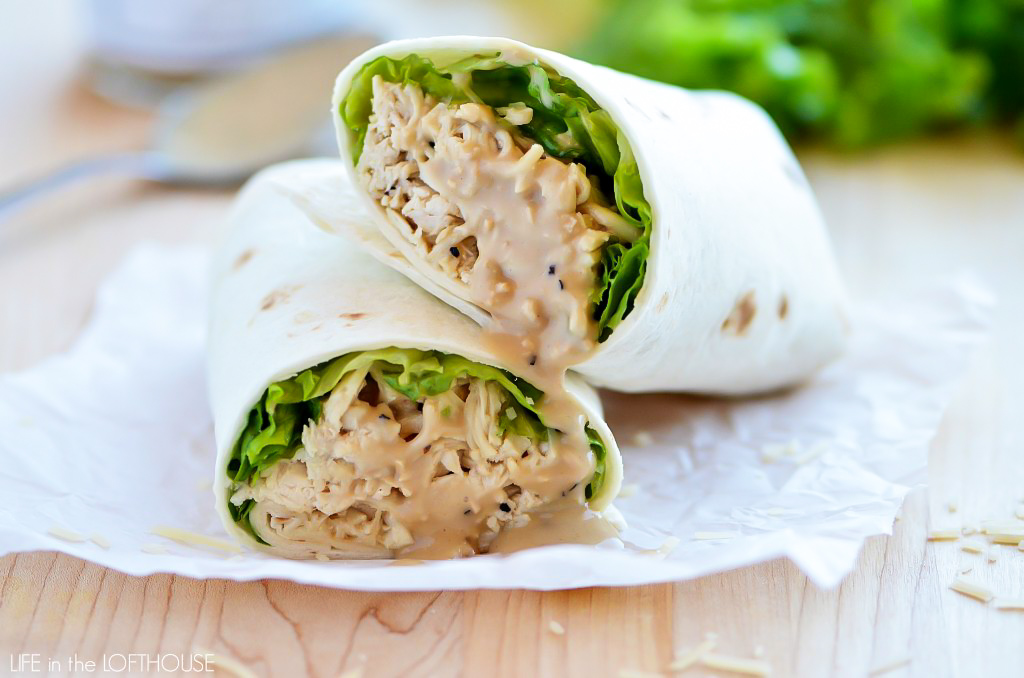 Crock Pot Chicken Caesar Wraps have flavorful Caesar chicken, lettuce and Parmesan cheese all wrapped up in a flour tortilla. Life-in-the-Lofthouse.com