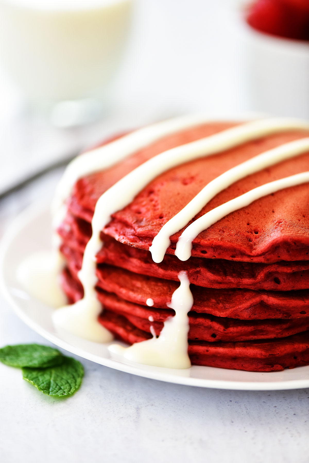 Red Velvet Pancakes are light and fluffy bright red pancakes with an incredible cream cheese glaze to drizzle over the tops. Life-in-the-Lofthouse.com
