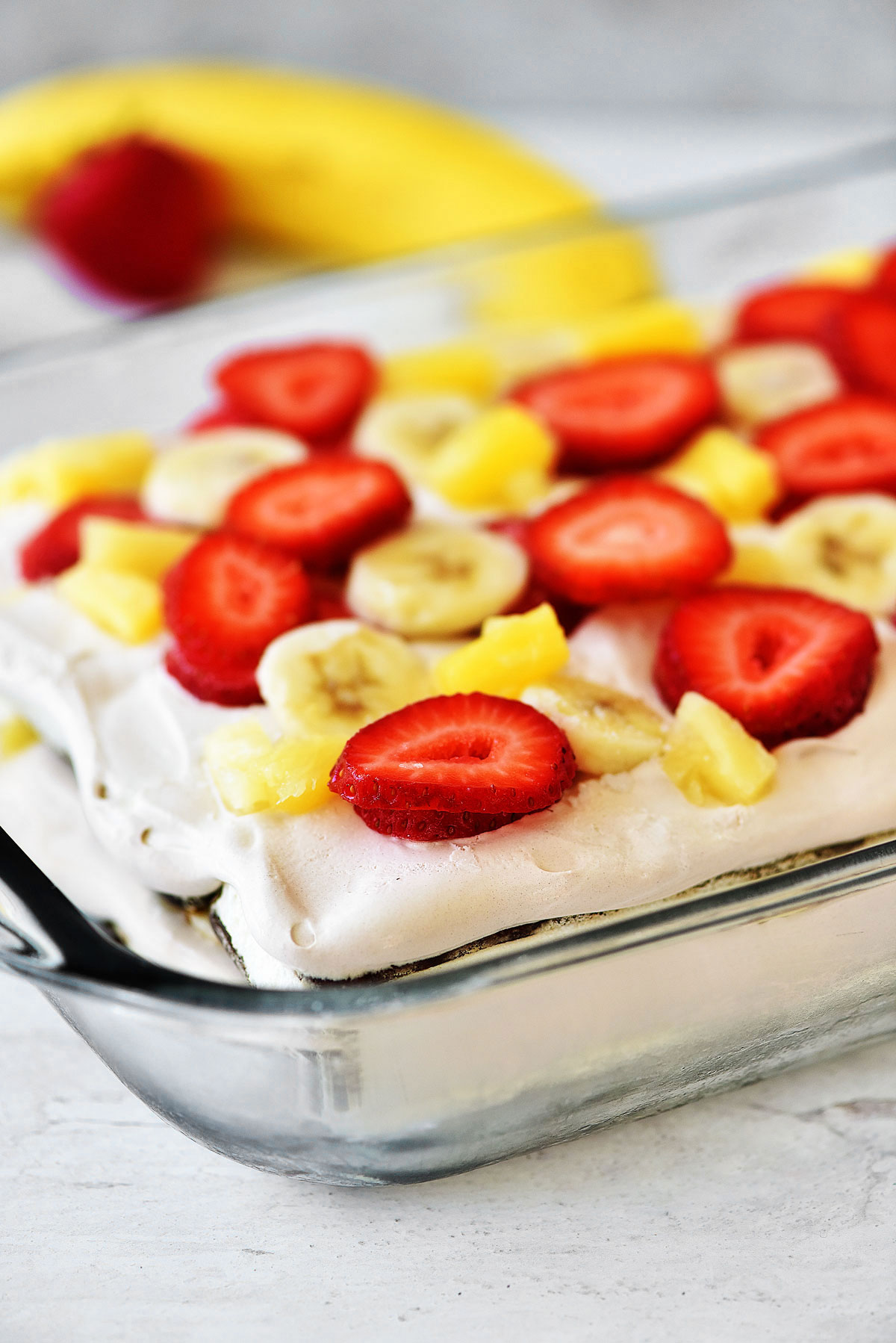 Banana Split Ice Cream Sandwich Cake has layers of ice cream sandwiches, Cool Whip and fresh fruit. Life-in-the-Lofthouse.com