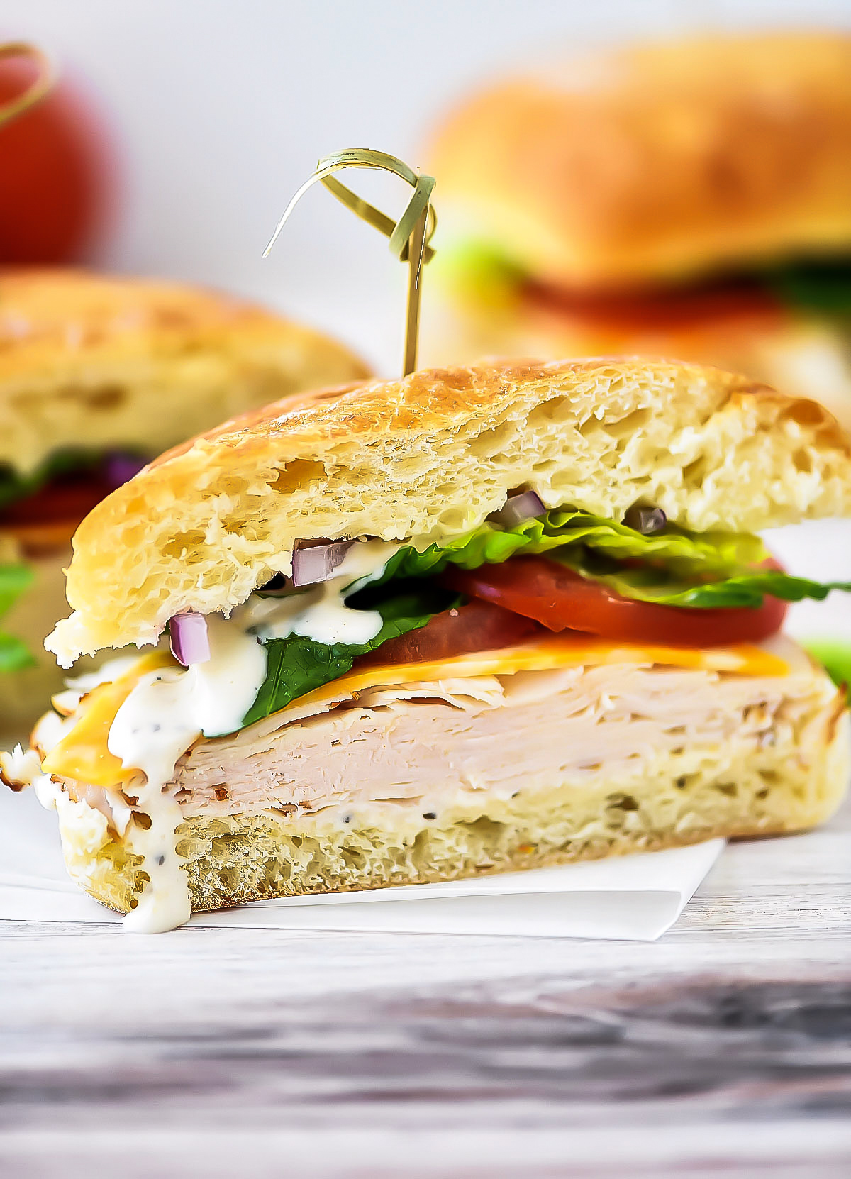 Chicken Caesar Sandwiches are chicken, cheese, lettuce and tomato between two Ciabatta rolls smothered with caesar dressing. Life-in-the-Lofthouse.com