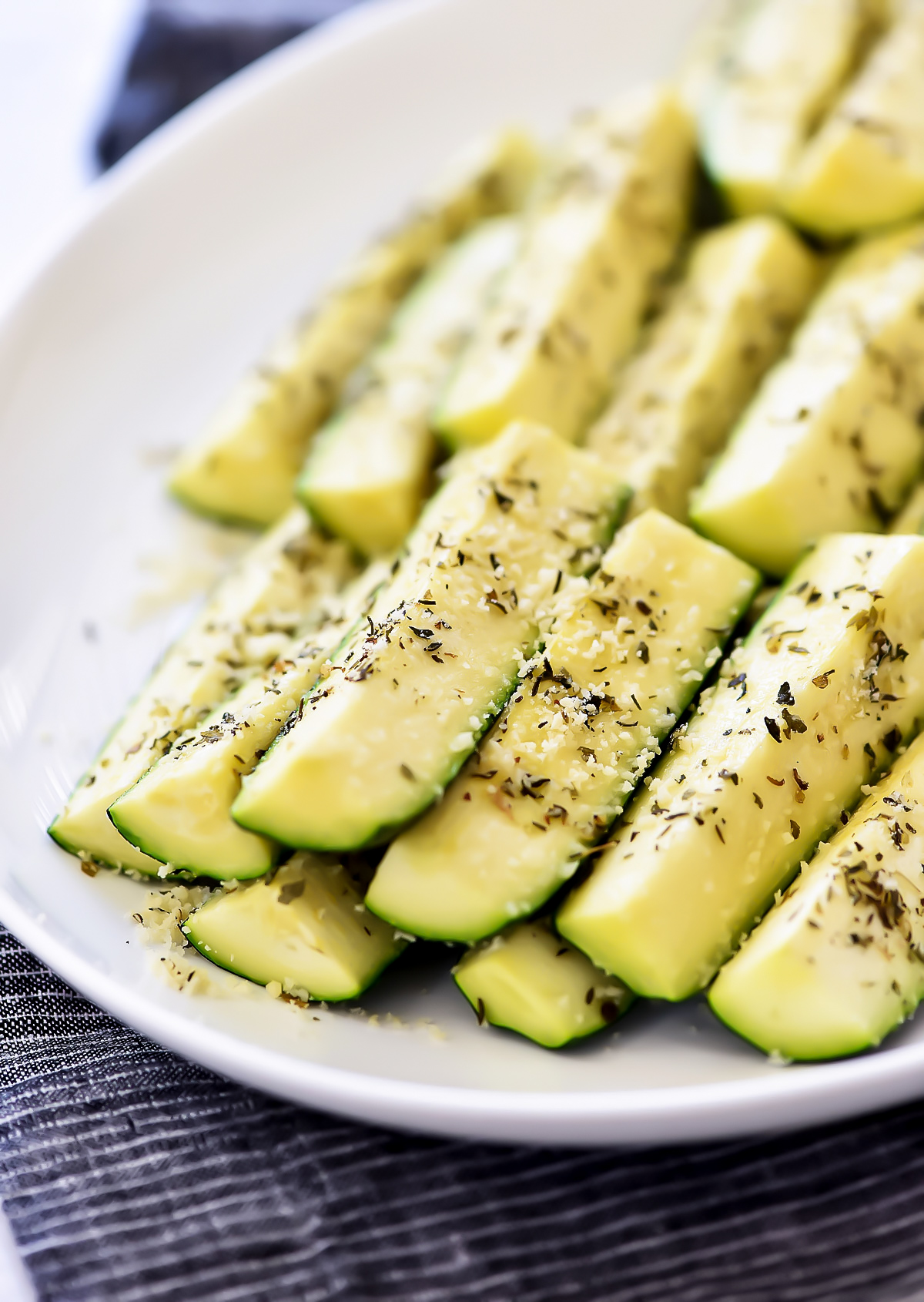 Baked zucchini covered in Parmesan cheese and full of Italian flavor. Life-in-the-Lofthouse.com