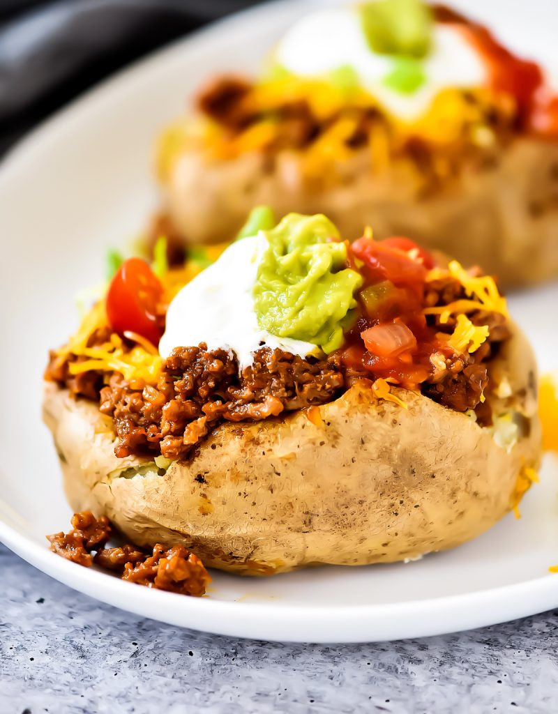 Taco Potatoes are loaded with seasoned ground beef, cheese, lettuce, sour cream and salsa all over a baked potato. Life-in-the-Lofthouse.com