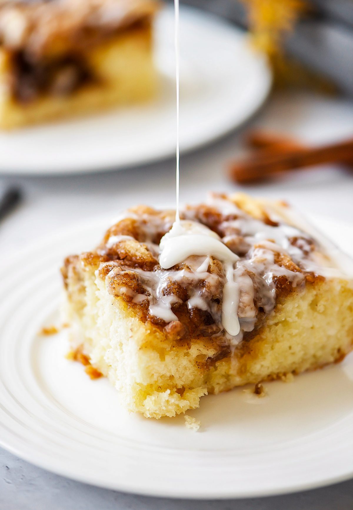 Cinnamon Roll Cake is a moist and buttery cinnamon cake with a creamy vanilla glaze drizzled over the top. Life-in-the-Lofthouse.com