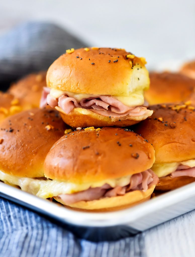 Ham and Cheese Sliders are savory and delicious baked ham sandwiches with a mustard poppy seed dressing. Life-in-the-Lofthouse.com