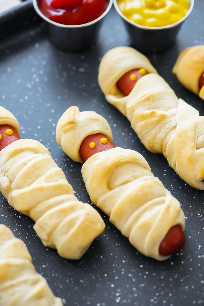 Mummy Hot dogs are hot dogs wrapped in flaky crescent dough to resemble mummies for Menu Plan Monday