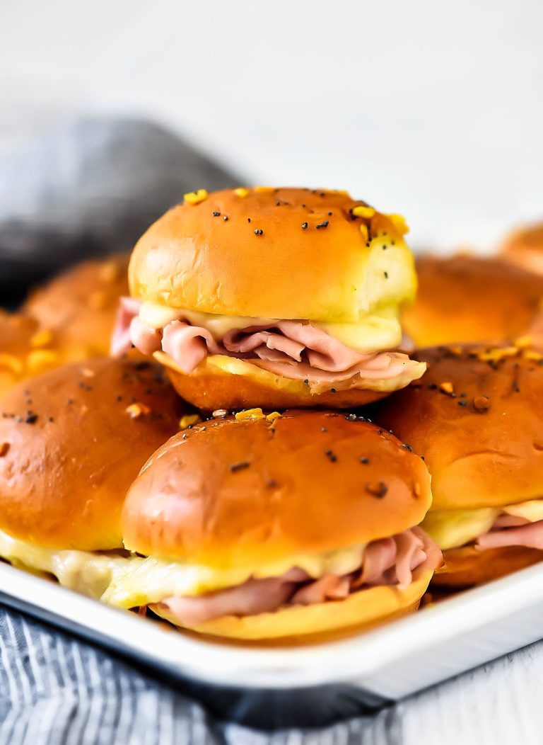 Ham and Cheese Sliders are savory and delicious baked ham sandwiches with a mustard poppy seed dressing. Life-in-the-Lofthouse.com