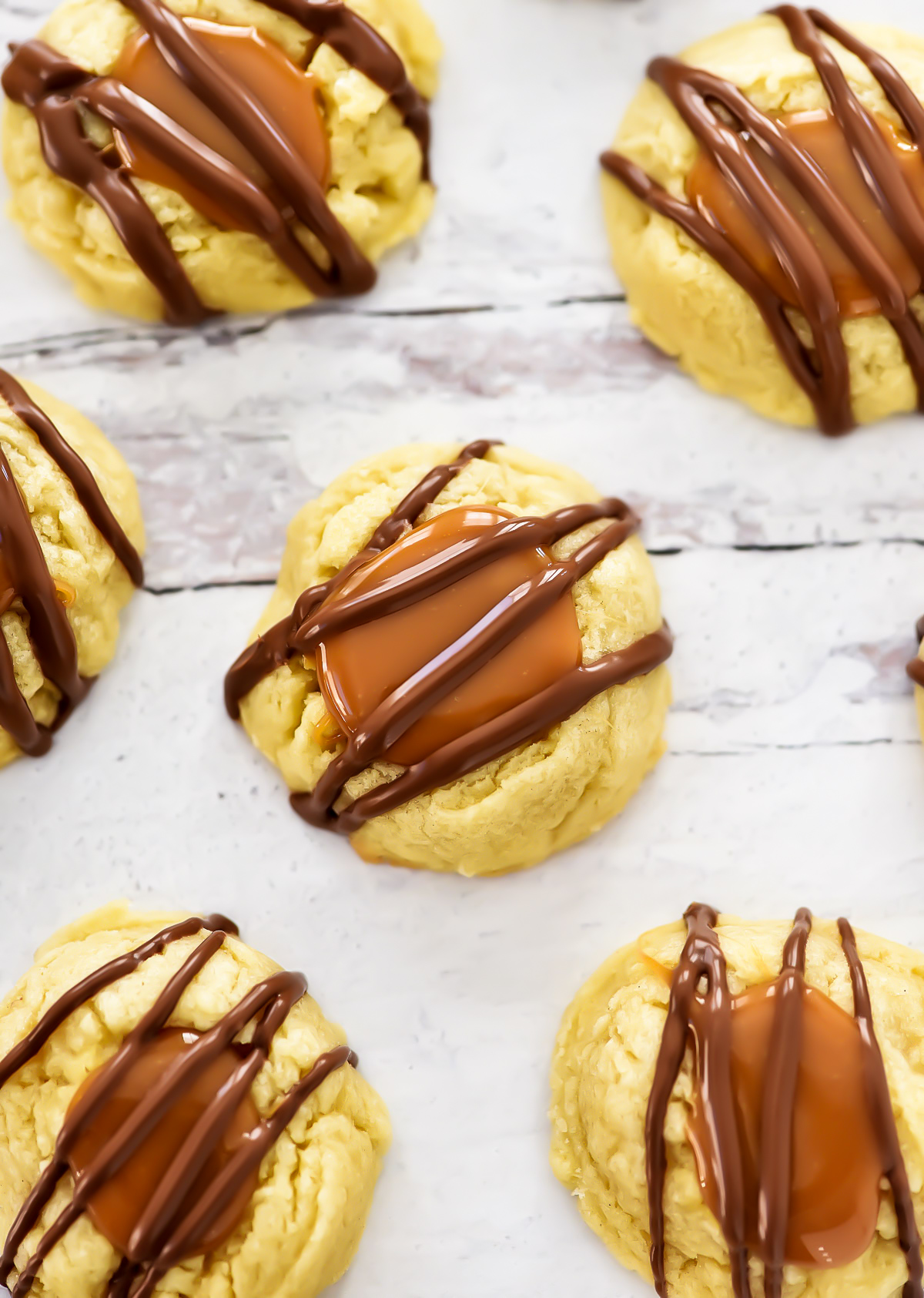 Twix Cookies start with a buttery thumbprint cookie topped with caramel and milk chocolate. Life-in-the-Lofthouse.com