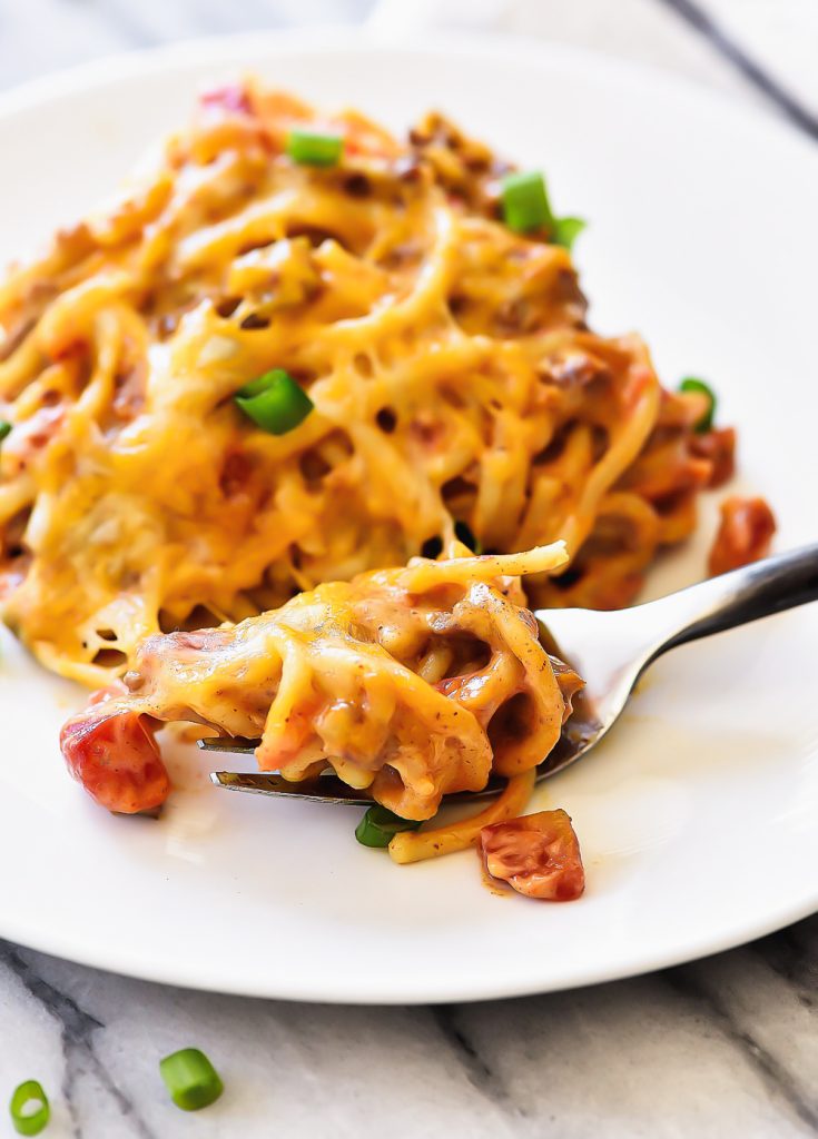 Taco Spaghetti is filled with ground beef, tomatoes, green chilies, taco seasonings and cheese with spaghetti noodles.