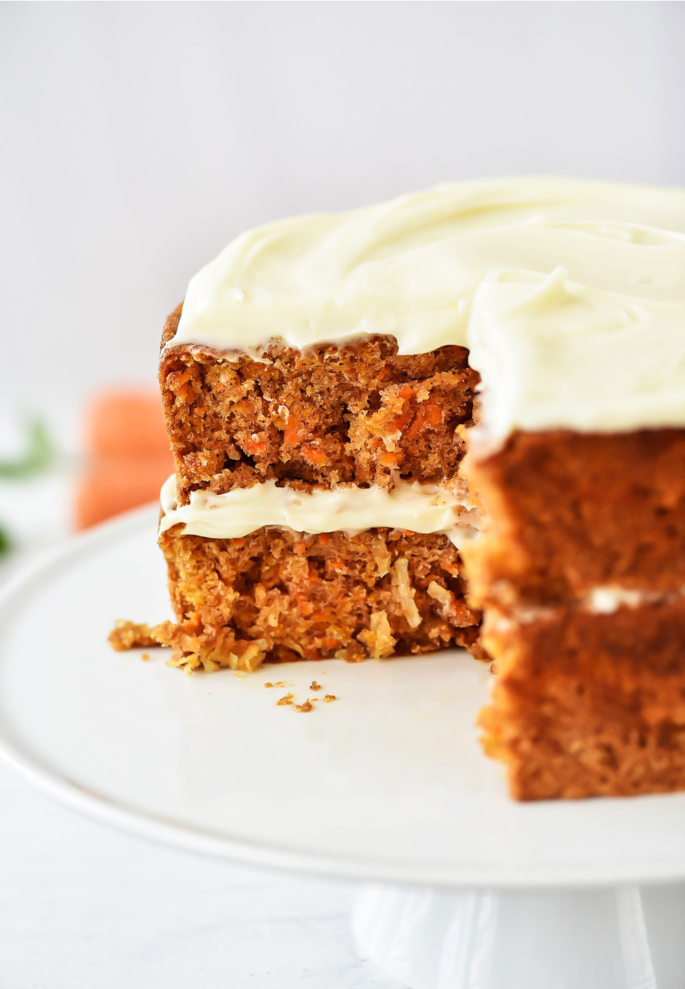 A delicious, moist cake filled with shredded carrots and coconut and topped off with a creamy Almond-Scented Cream Cheese Frosting. Life-in-the-Lofthouse.com