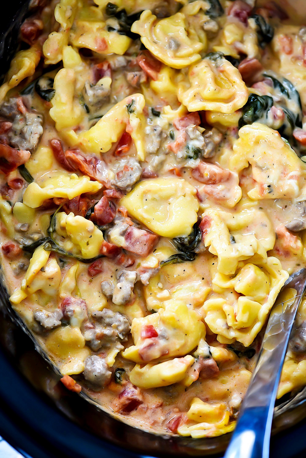Sausage, cheese tortellini, spinach, diced tomatoes and cheese create this Slow Cooker Sausage and Cheese Tortellini. Life-in-the-Lofthouse.com