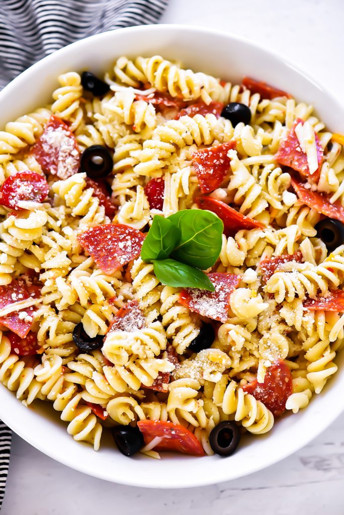 Tender pasta, zesty pepperoni and Italian dressing come together to create this Pepperoni Pizza Pasta Salad. Enjoy the perfect potluck or barbecue side dish that has all of the delicious flavors of pizza! Perfect for Menu Plan Monday.