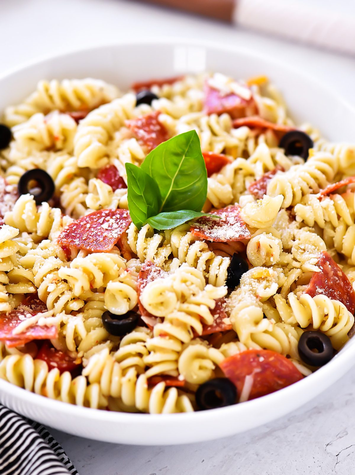 Tender pasta, zesty pepperoni and Italian dressing come together to create this Pepperoni Pizza Pasta Salad. Enjoy the perfect potluck or barbecue side dish that has all of the delicious flavors of pizza!