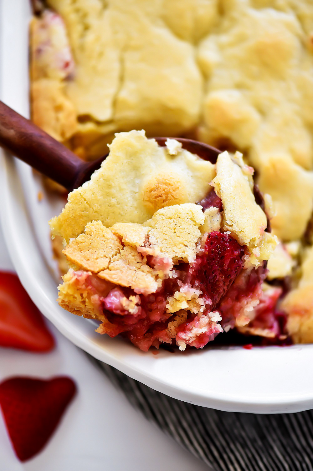 A warm baked dessert with fresh strawberries and a soft cookie crust.