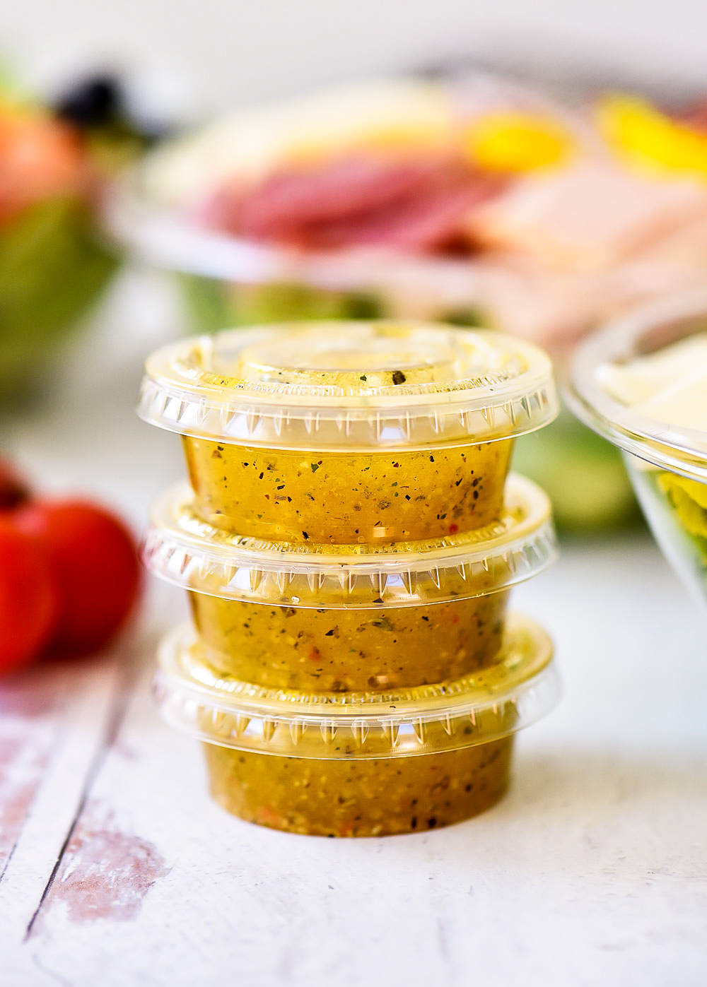 Italian Sub Salad is filled with sliced turkey, salami, provolone cheese, banana peppers, sliced olives and cherry tomatoes. Life-in-the-Lofthouse.com