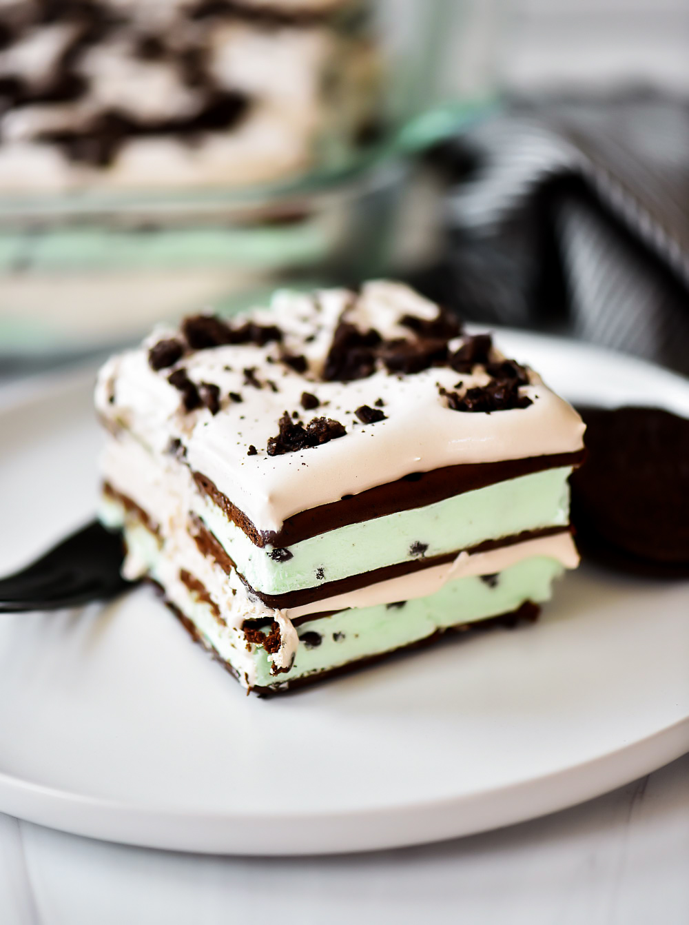 Layers of mint chocolate ice cream sandwiches, Cool Whip, and crushed Oreo cookie create one incredible dessert.